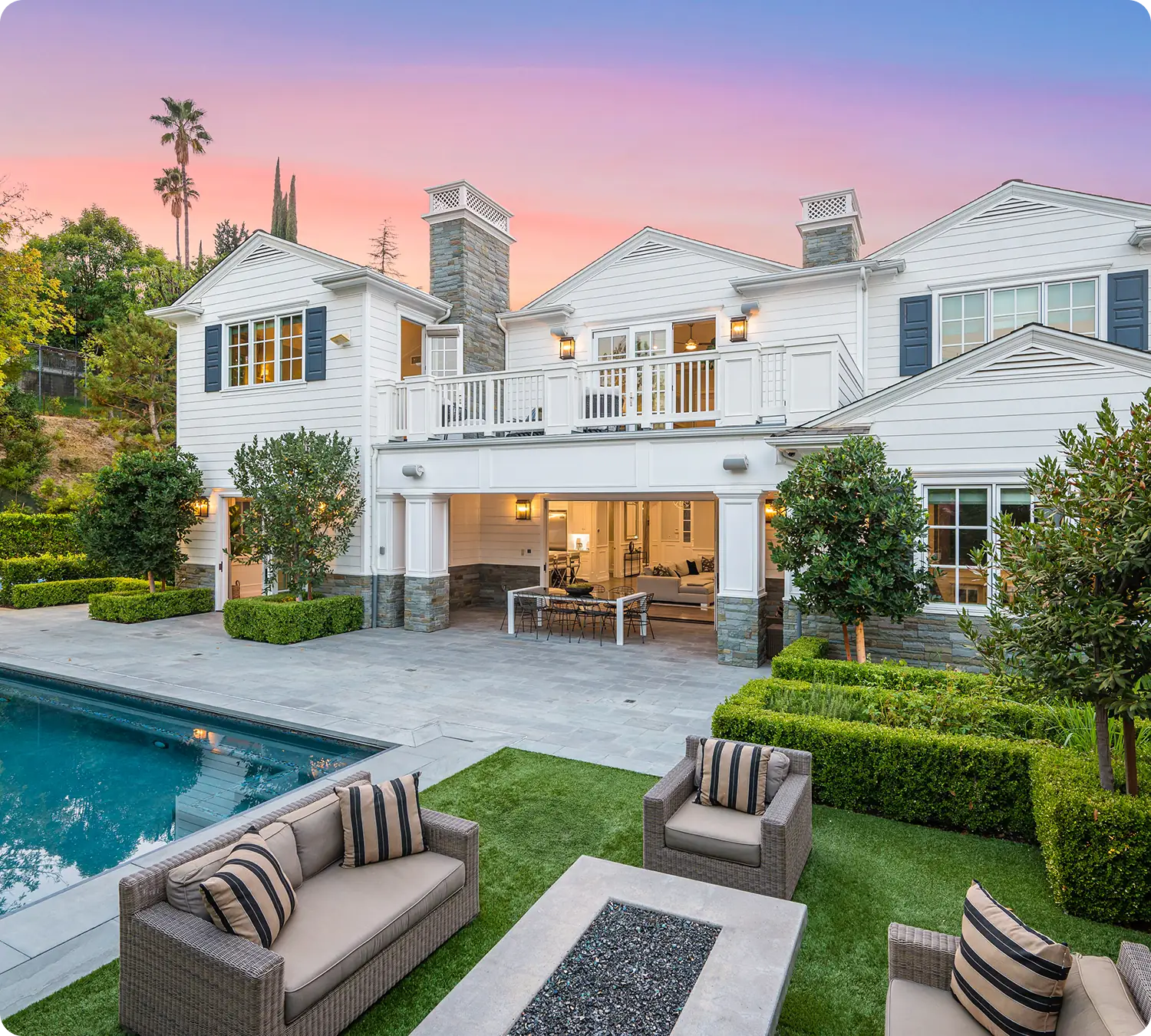 Luxury house with pool at sunset.