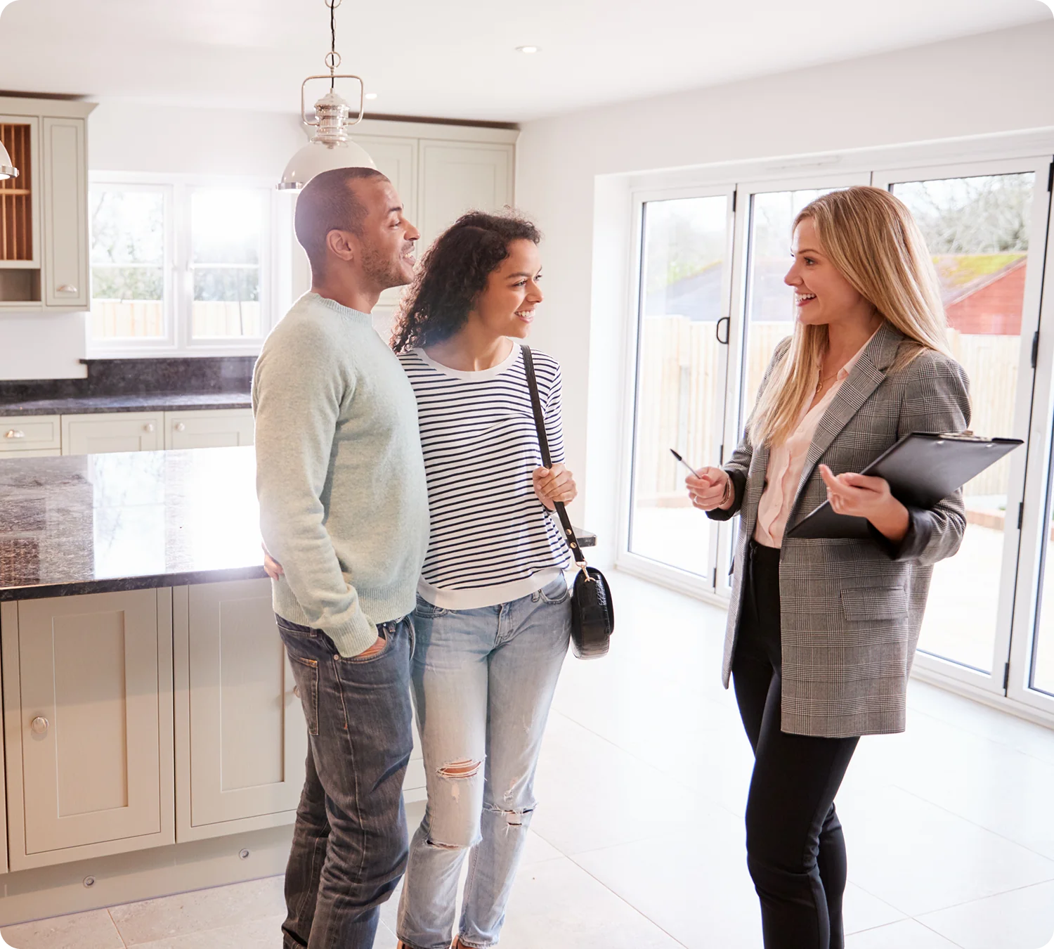 Couple viewing house with real estate agent.