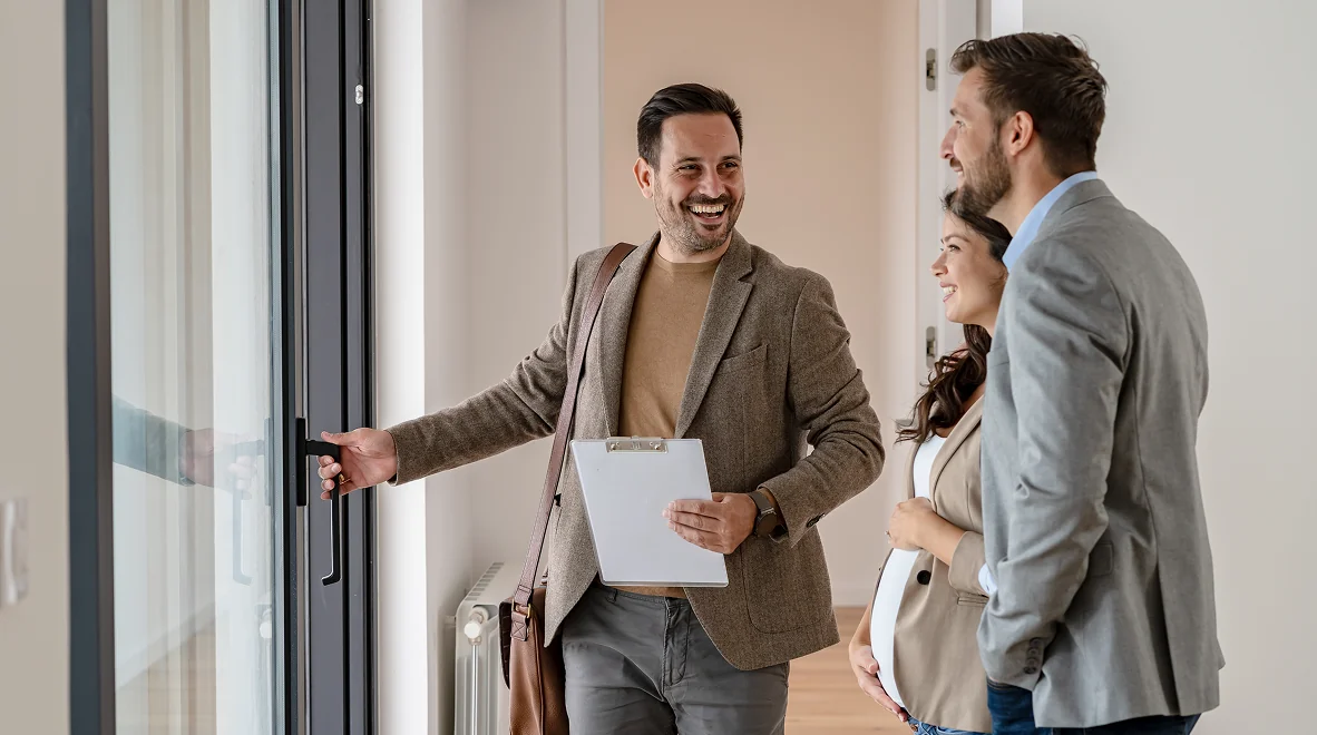 Real estate agent showing couple a house.