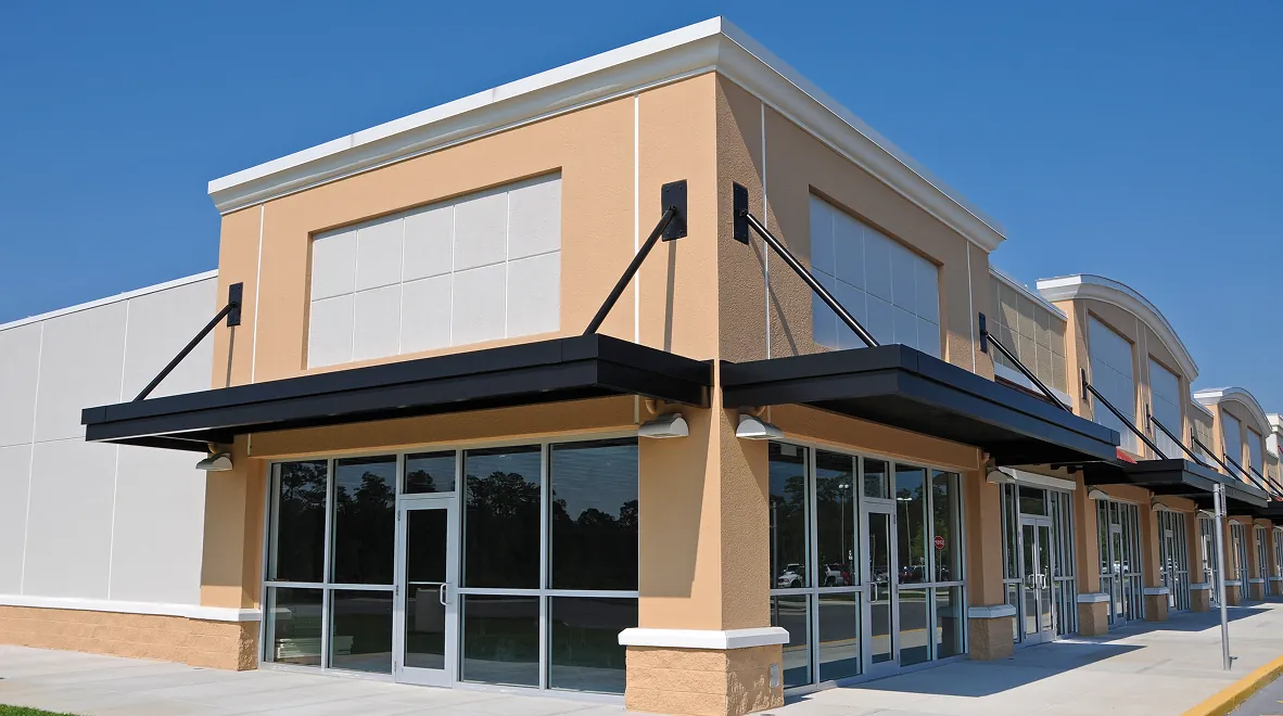 Modern commercial building with large glass windows.