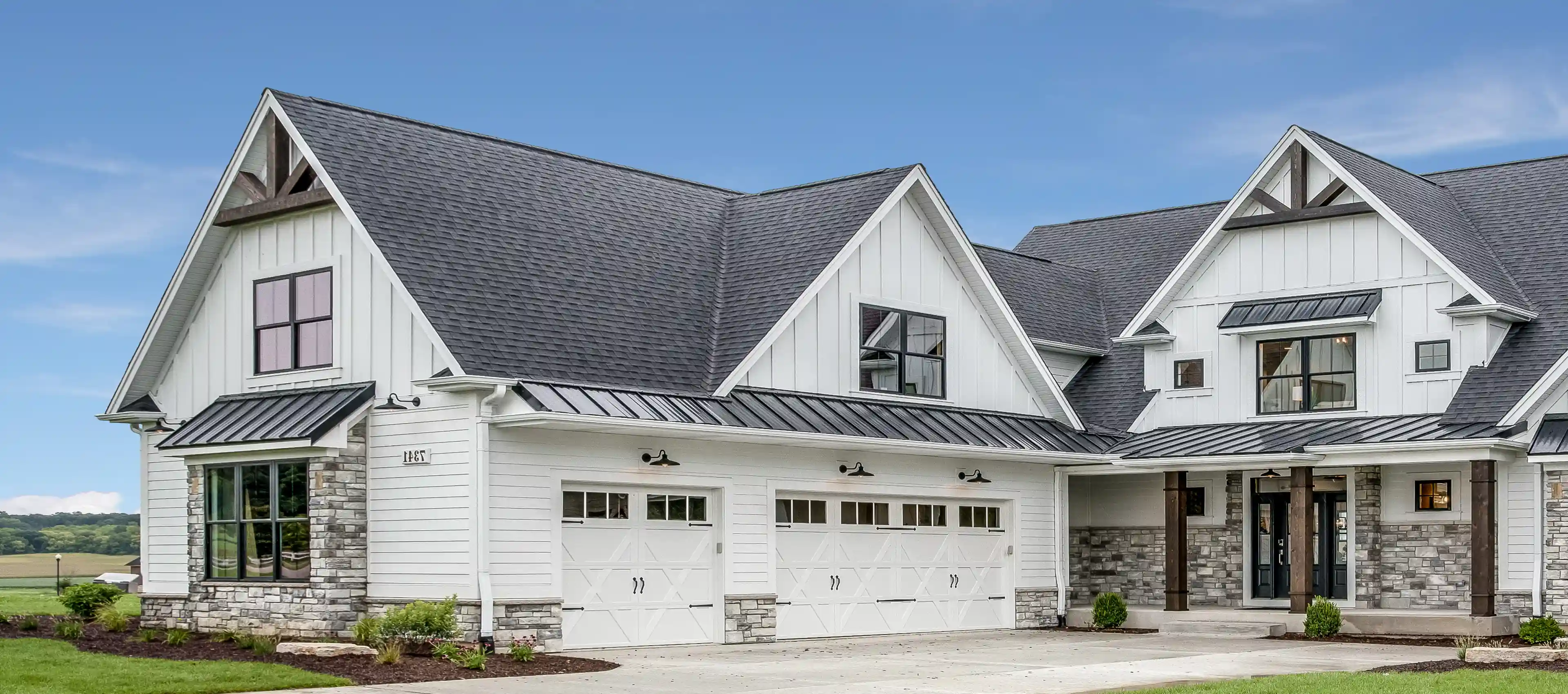 Modern white house with gray roof.